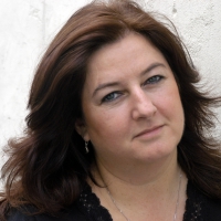 A close-up headshot of Julie Peakman looking forward