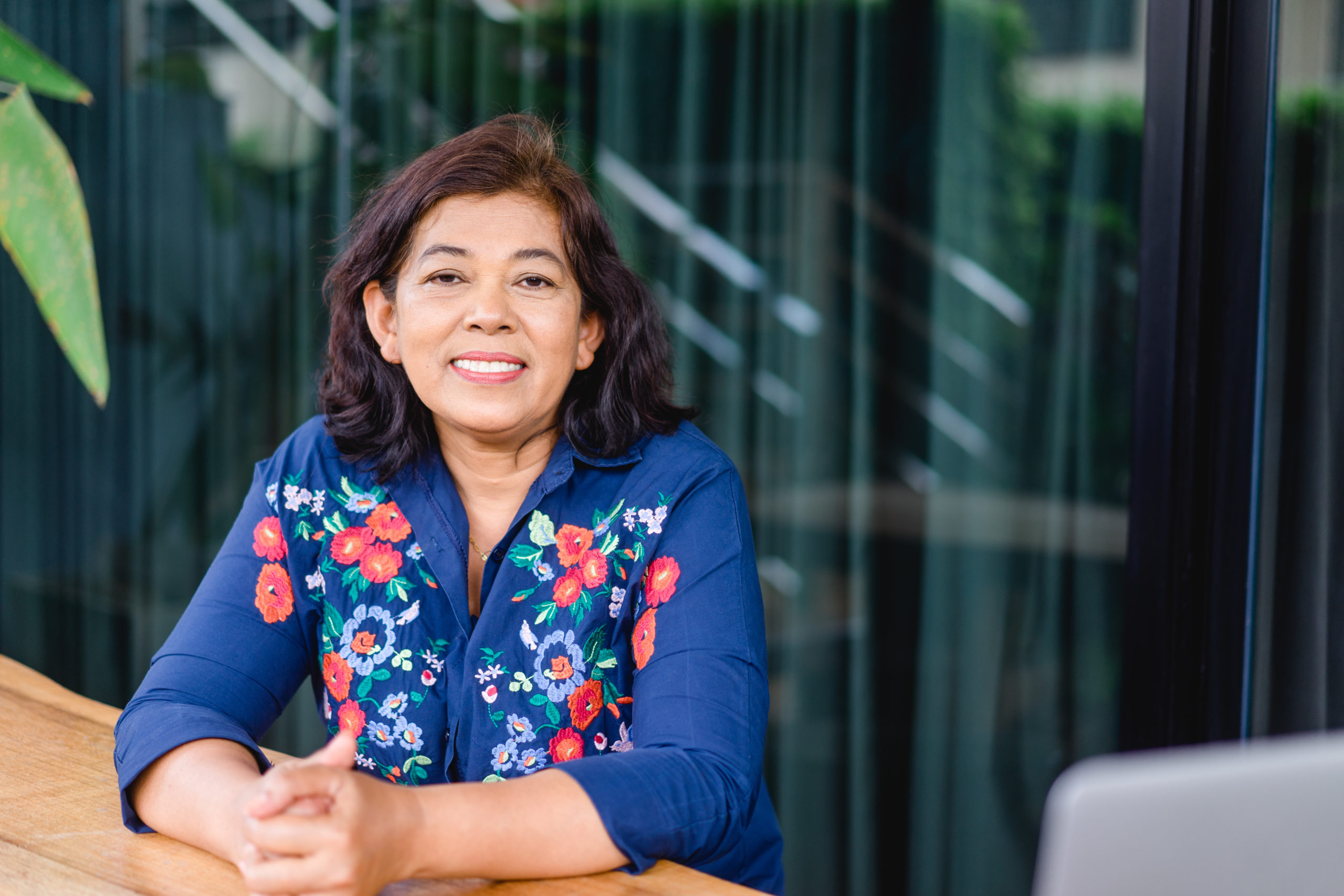 Portrait of senior woman smiling from a table