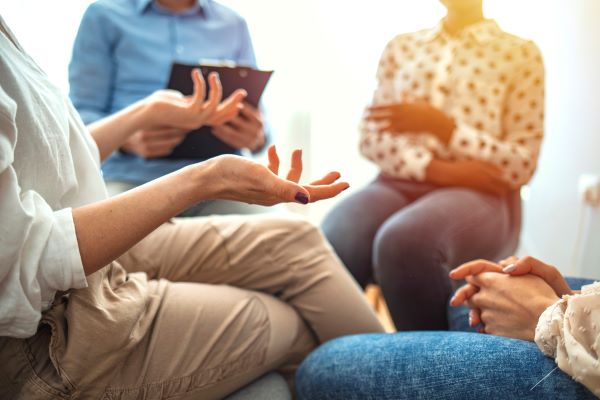 A group discussion with focus on a participant's hands