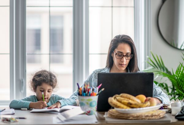 Mother and daughter work side by side from home 