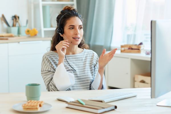 Professional working from home, connecting with remote team via video conference call.