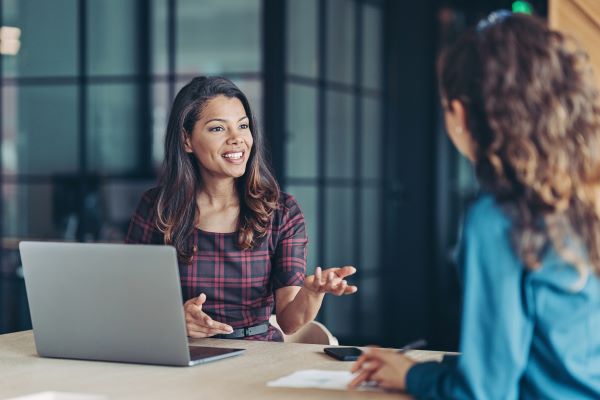 Mid-career higher ed professional mentoring a colleague