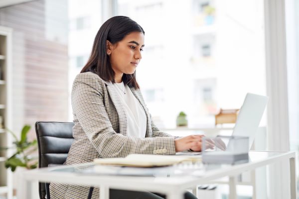 Higher ed job seeker taking survey on laptop