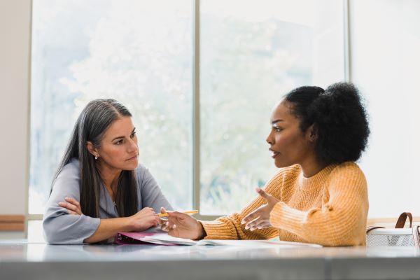 Two higher ed professionals having 'the talk' - a discussion about an important concern.