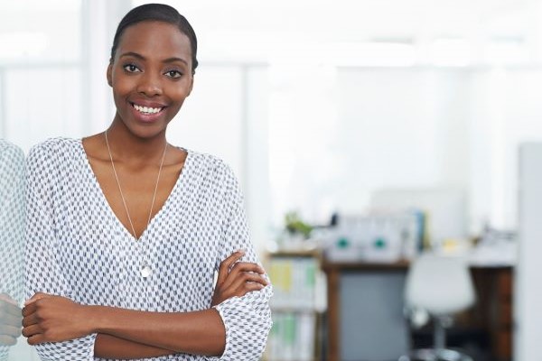 Higher ed professional in the office, smiling at camera