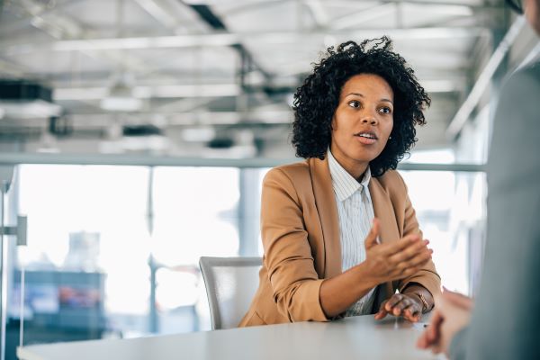 Higher ed professional speaking to colleague