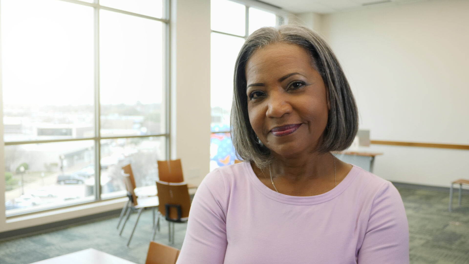 Confident mature African American woman looks at the camera with a slight smile.