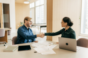 Salary Negotiation: A job candidate shakes hands with hiring manager after salary discussion